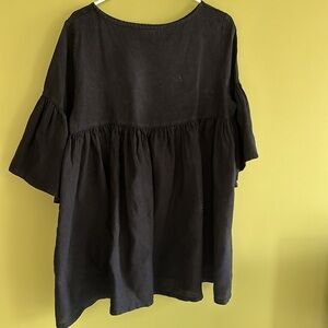 Bryn Walker black linen tunic top with gathered back detail and ruffle sleeves.